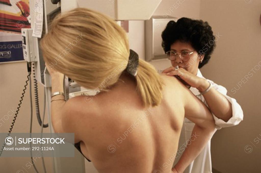 Stock Photo: 292-1124A Female doctor preparing a patient for a mammogram