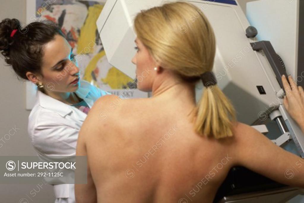 Stock Photo: 292-1125C Female doctor preparing a patient for mammography