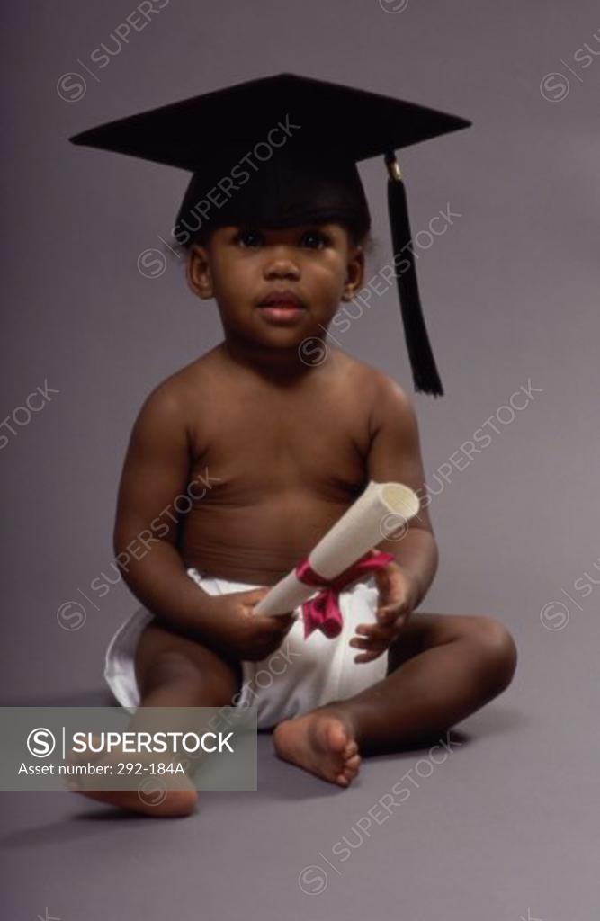 Stock Photo: 292-184A Baby wearing a mortar board and holding a diploma