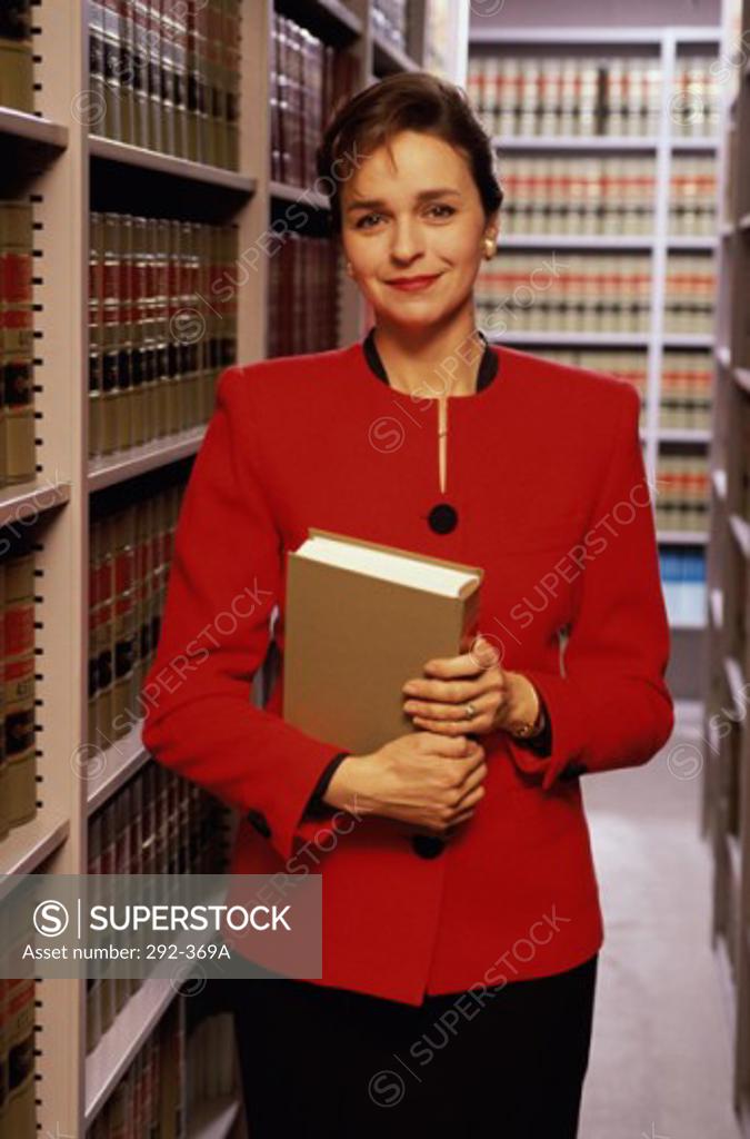 Stock Photo: 292-369A Female lawyer holding a book and grinning