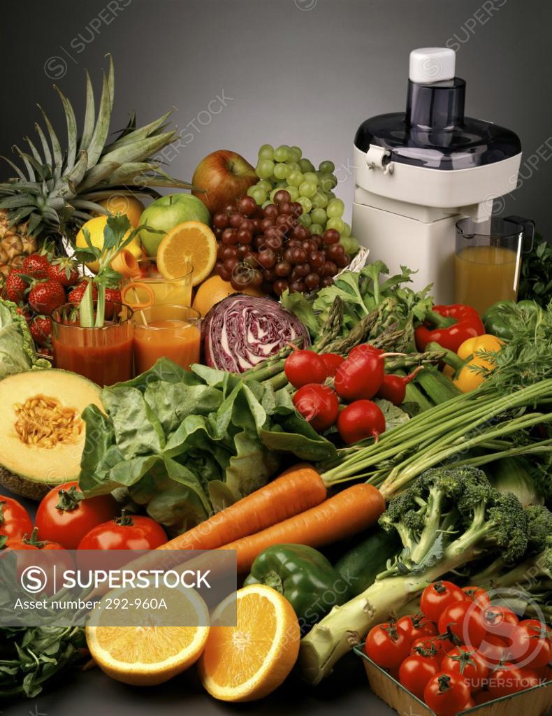 Stock Photo: 292-960A Fruits and vegetables with an electric juicer