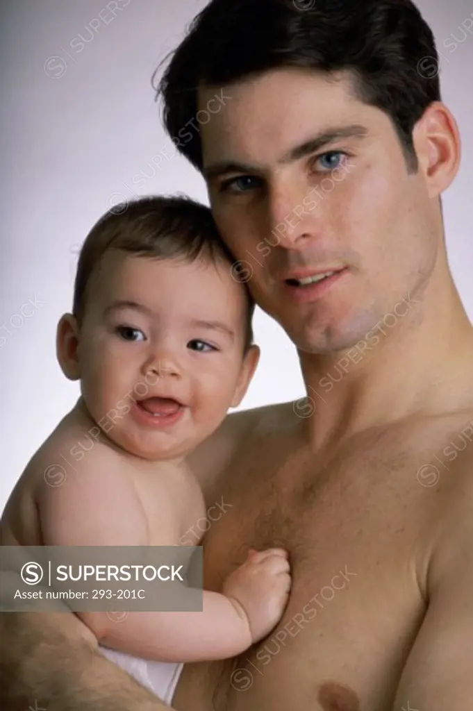 Close-up of a young man holding his baby