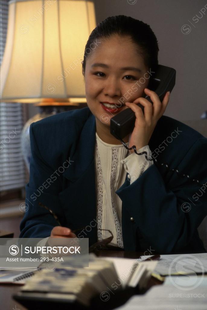 Stock Photo: 293-435A Businesswoman talking on the telephone smiling