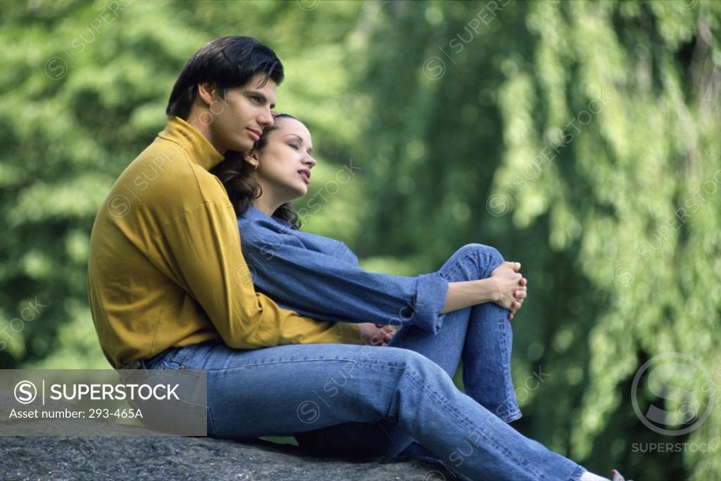 Stock Photo: 293-465A Young couple sitting on a rock