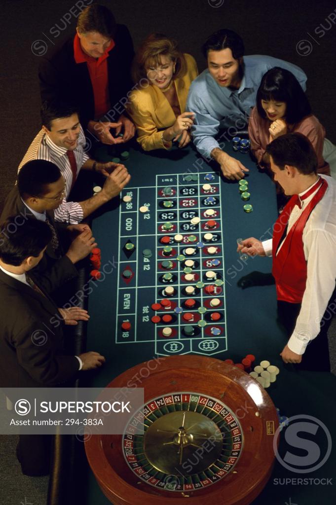 Stock Photo: 294-383A High angle view of a group of people at a roulette table