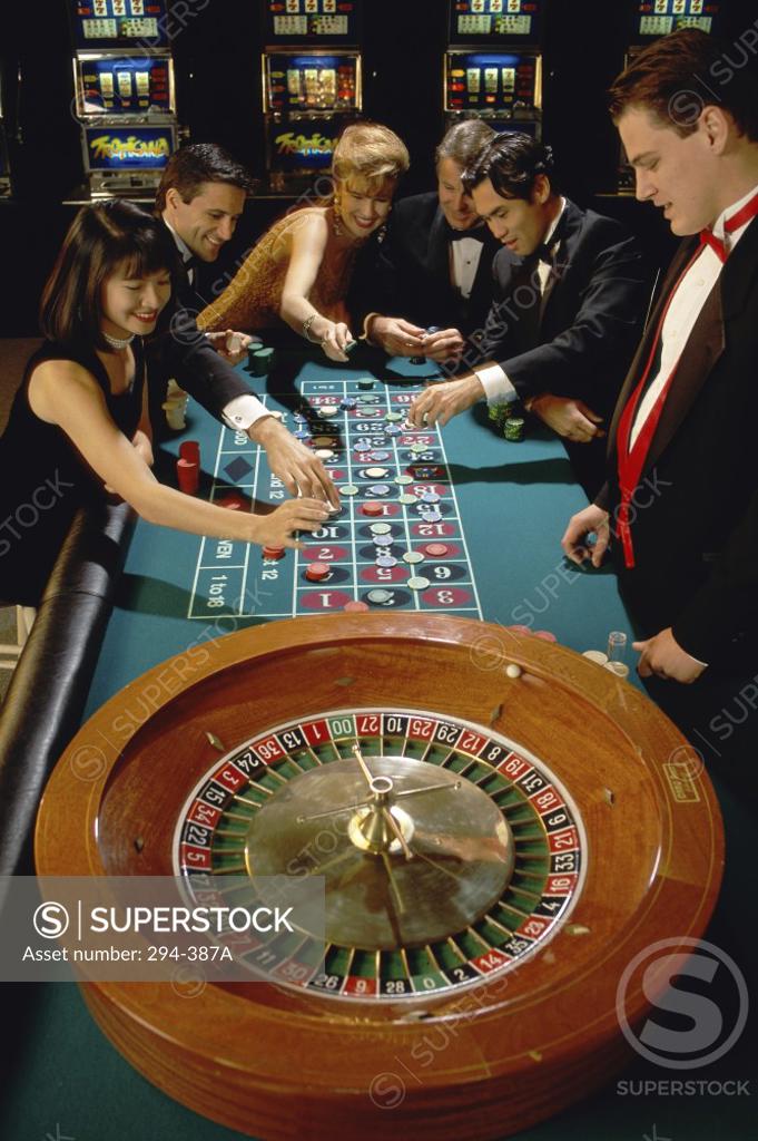Stock Photo: 294-387A Group of people playing at a roulette table in a casino