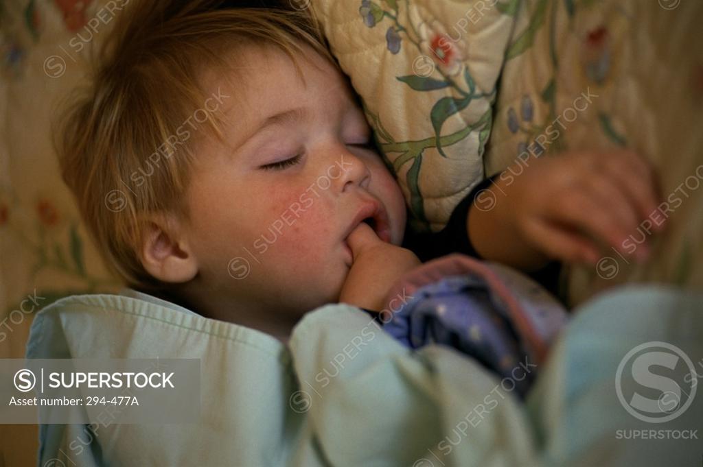 Stock Photo: 294-477A High angle view of a baby sleeping on the bed
