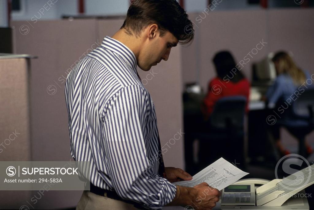 Stock Photo: 294-583A Businessman reading a document in an office