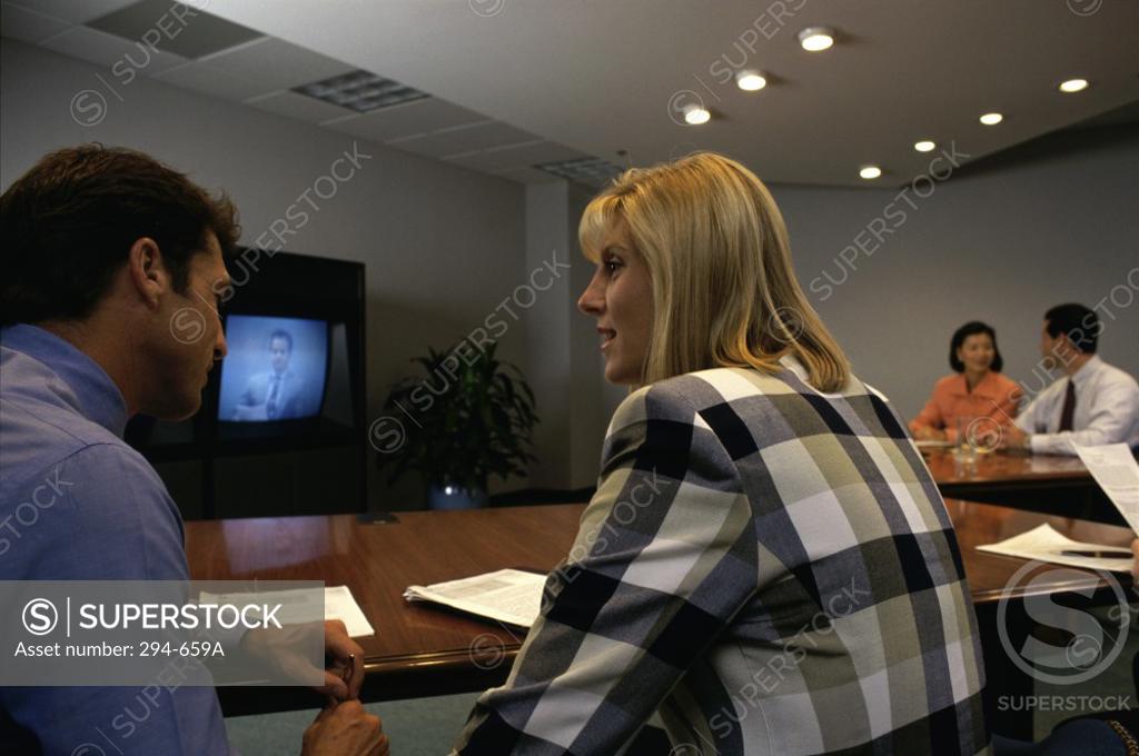 Stock Photo: 294-659A Businessman and a businesswoman talking in a video conference