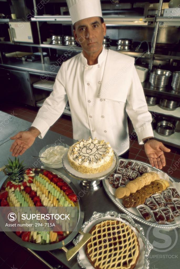 Stock Photo: 294-715A Chef standing in a kitchen and presenting food