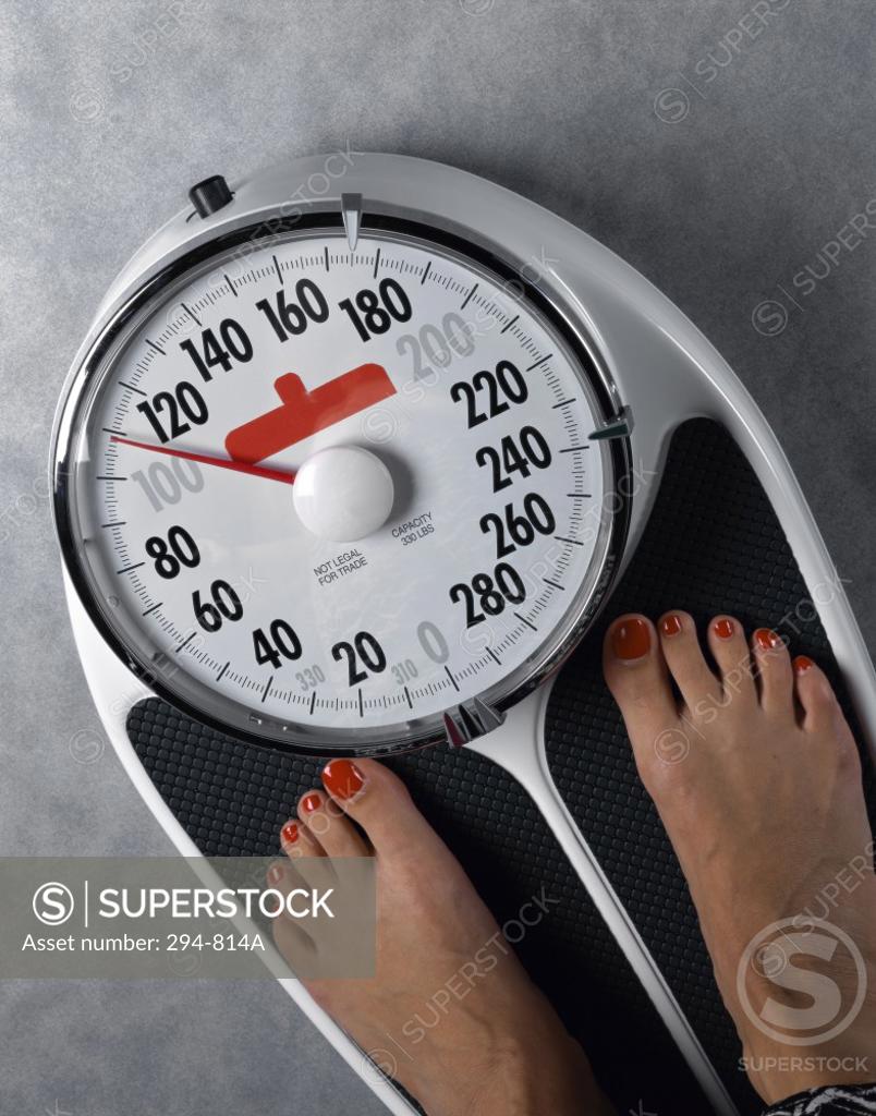 Stock Photo: 294-814A High angle view of a woman's feet on a weighing scale