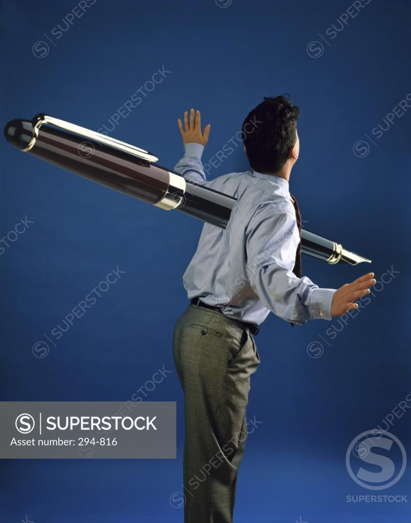 Stock Photo: 294-816 Businessman with a large fountain pen through him
