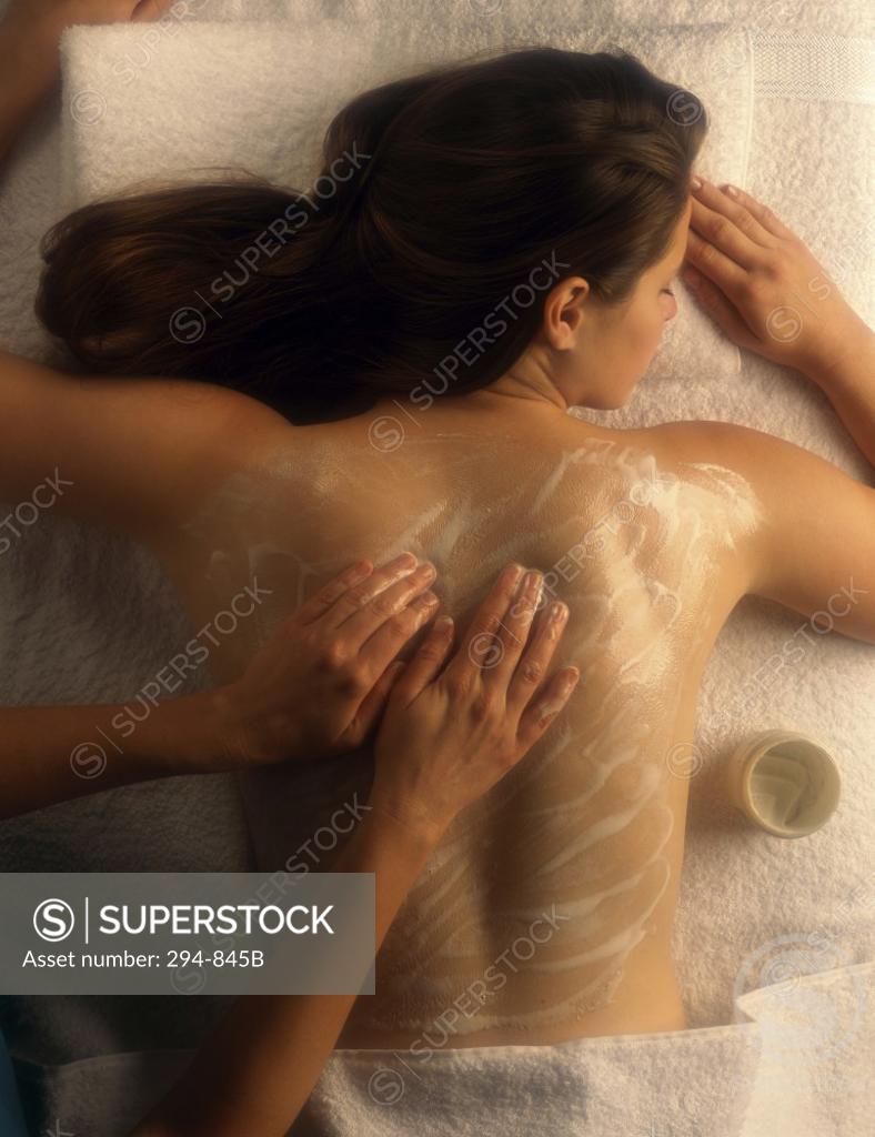Stock Photo: 294-845B Rear view of a young woman receiving a back massage from a massage therapist