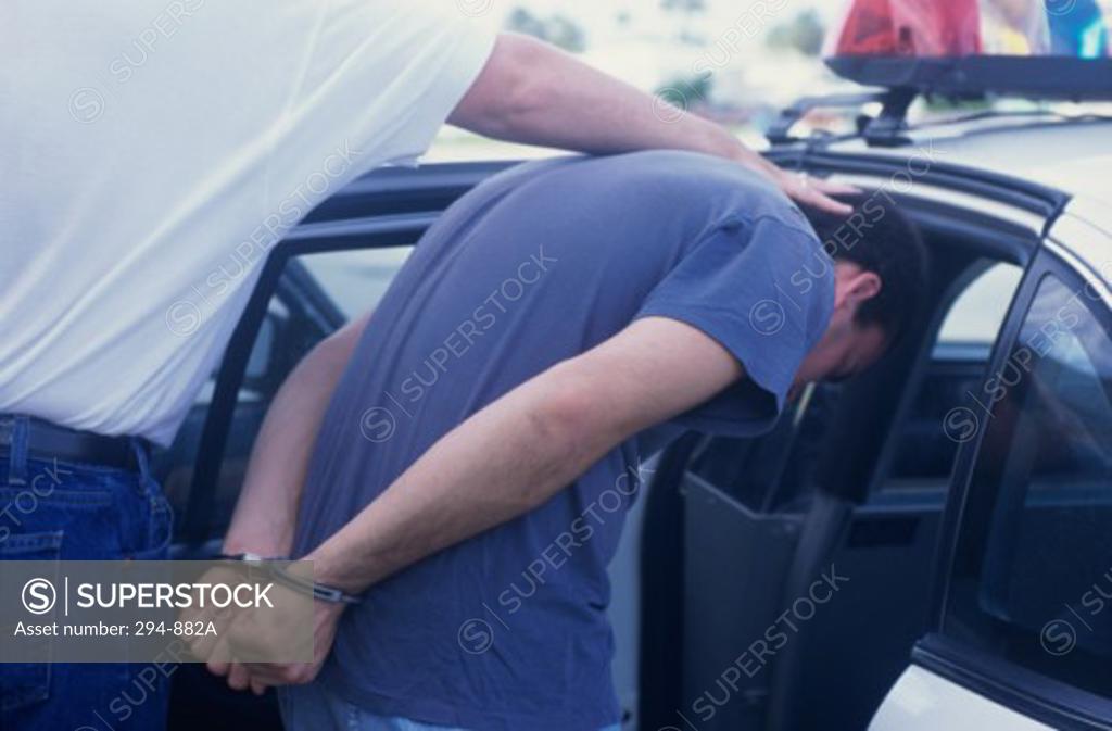 Stock Photo: 294-882A Police officer arresting a criminal