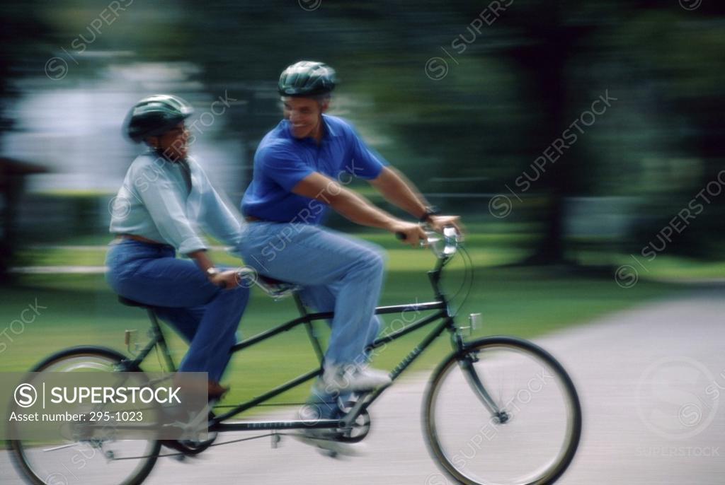 Stock Photo: 295-1023 Mature couple riding a tandem bicycle