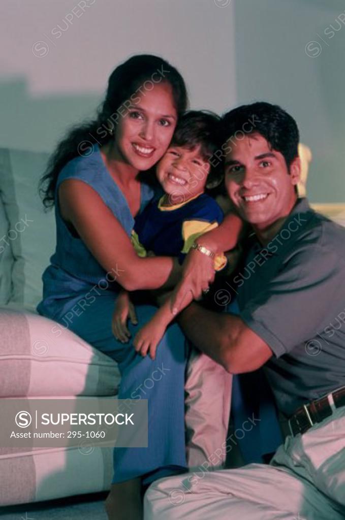 Stock Photo: 295-1060 Portrait of a mid adult couple hugging their son and smiling
