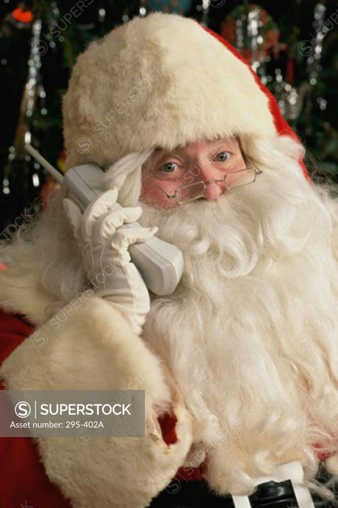Stock Photo: 295-402A Close-up of Santa Claus talking on a cordless phone