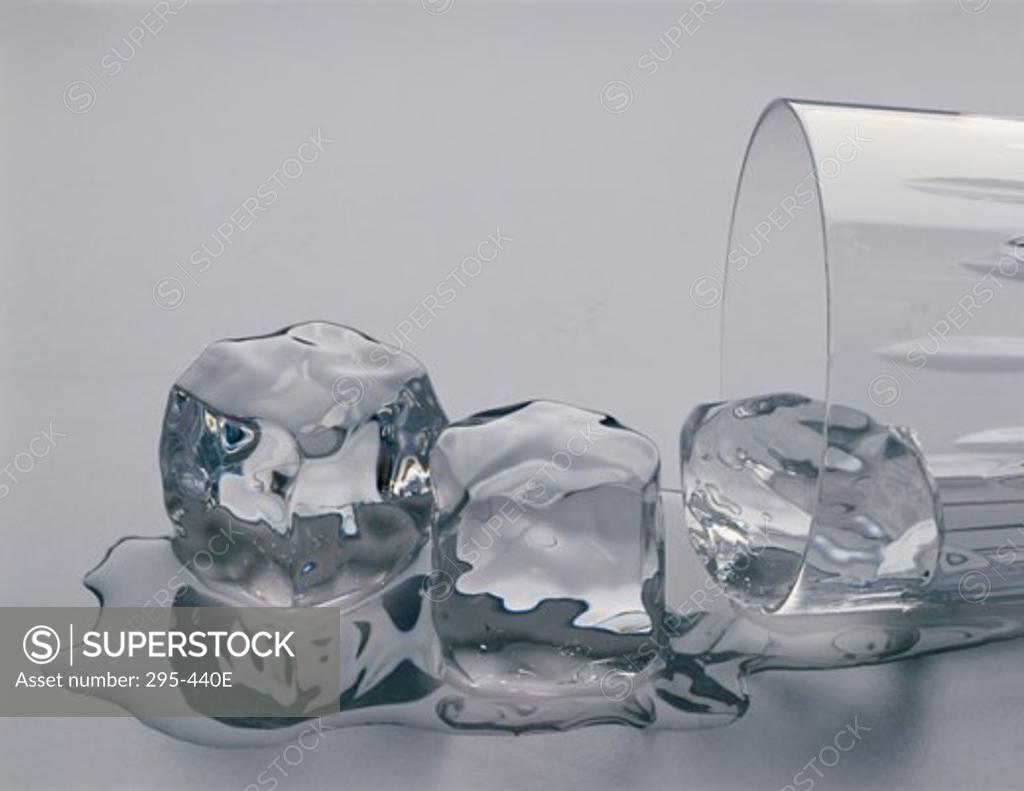 Stock Photo: 295-440E Close-up of three melting ice cubes spilling out from a fallen glass