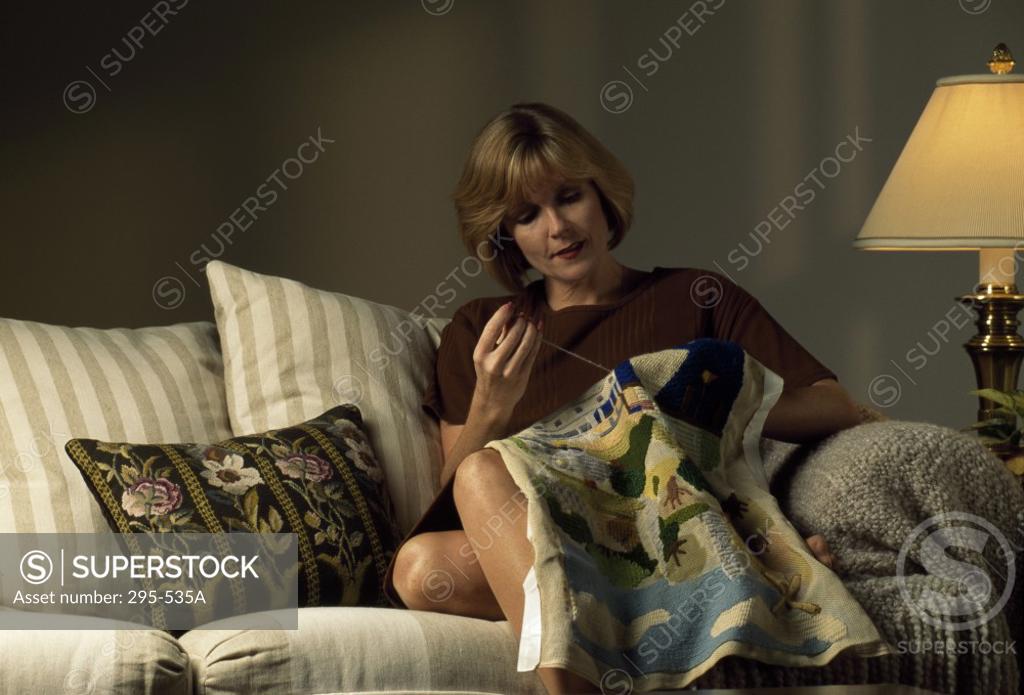 Stock Photo: 295-535A Mid adult woman working on a quilt