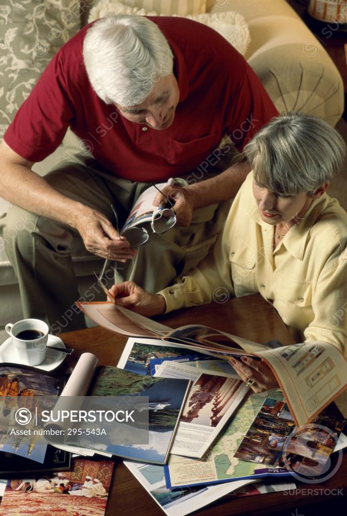 Stock Photo: 295-543A High angle view of a senior couple reading a travel guidebook