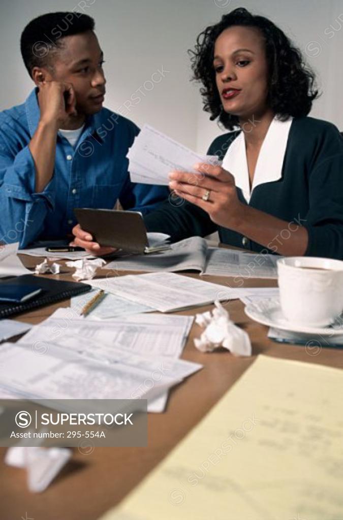 Stock Photo: 295-554A Young couple working together and sorting bills