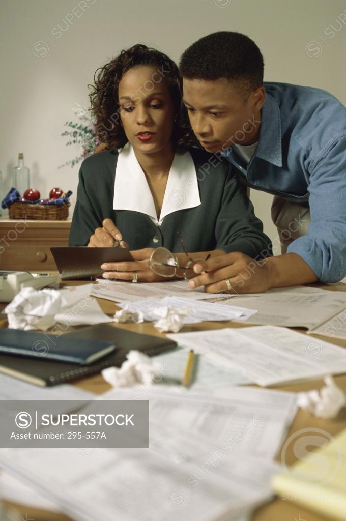 Stock Photo: 295-557A Young couple sorting out bills