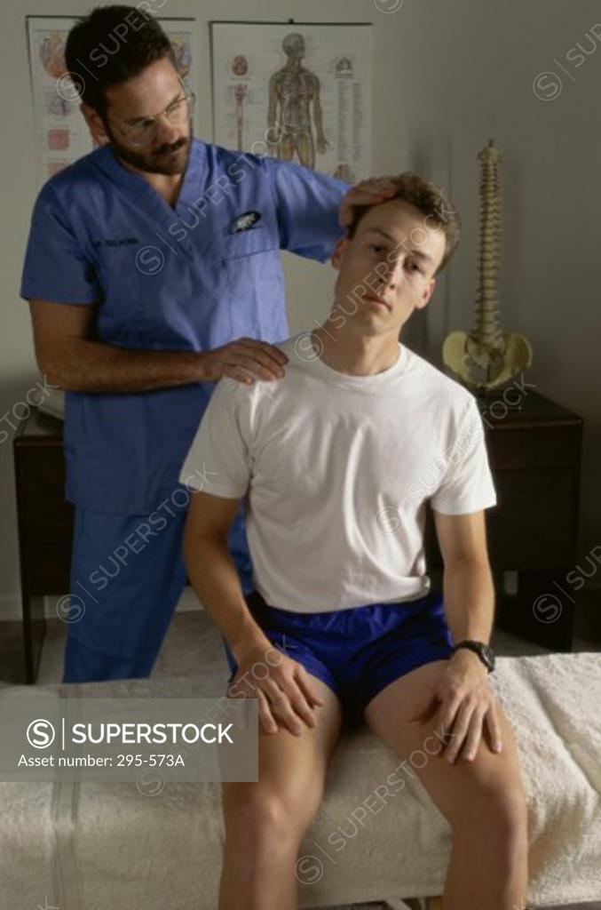 Stock Photo: 295-573A Male chiropractor examining a patient in a doctor's office