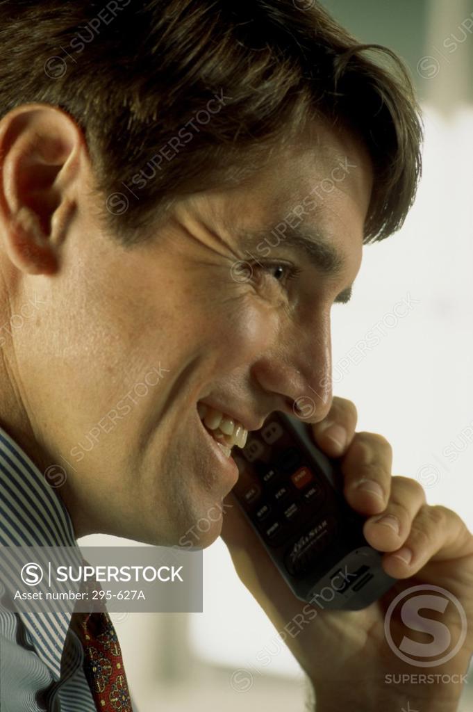 Stock Photo: 295-627A Businessman talking on a cordless phone