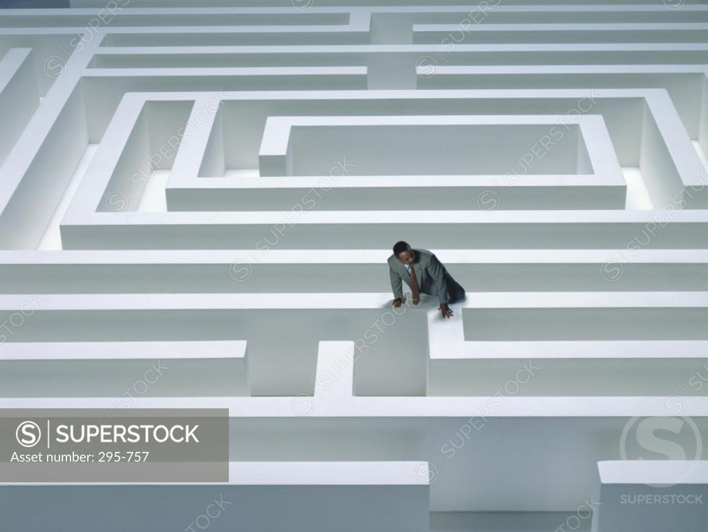 Stock Photo: 295-757 High angle view of a businessman climbing a maze