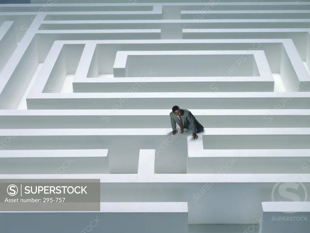 High angle view of a businessman climbing a maze