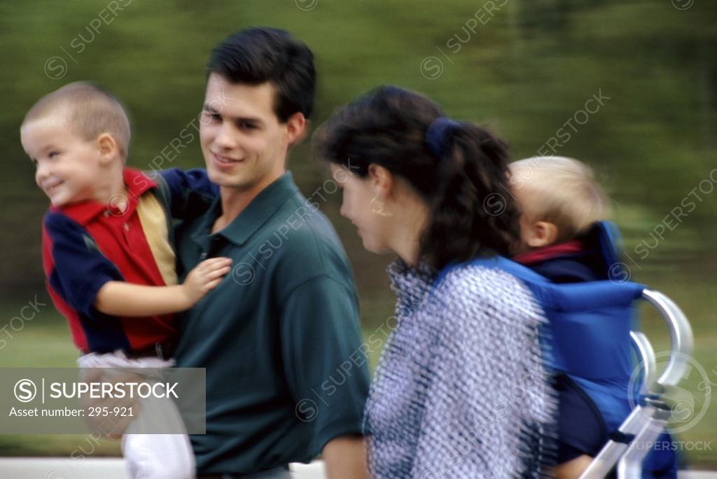 Stock Photo: 295-921 Young couple carrying their sons