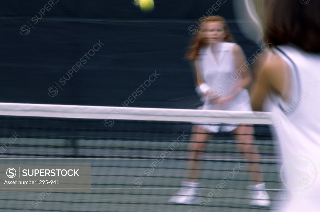 Stock Photo: 295-941 Two young women playing tennis