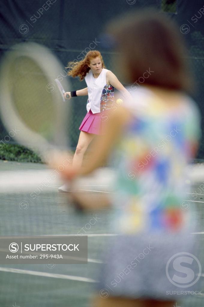 Stock Photo: 295-943A Two young women playing tennis
