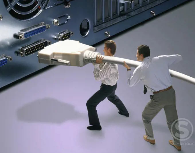 High angle view of two businessmen connecting a computer cable