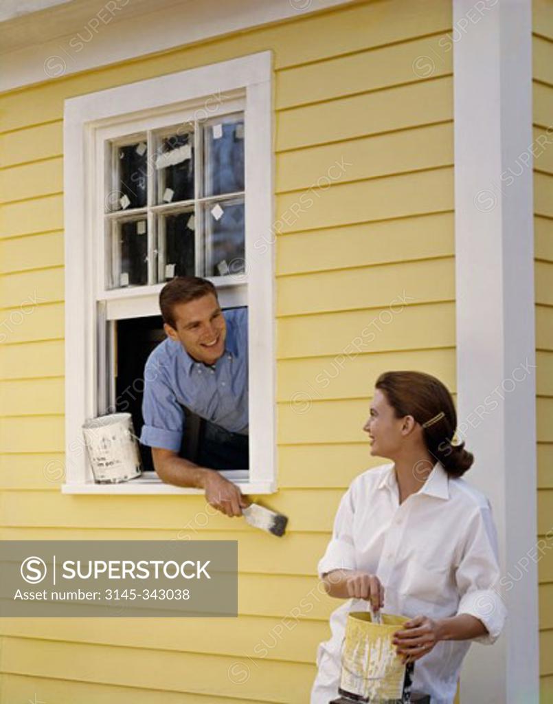 Stock Photo: 3145-343038 Young couple painting their house