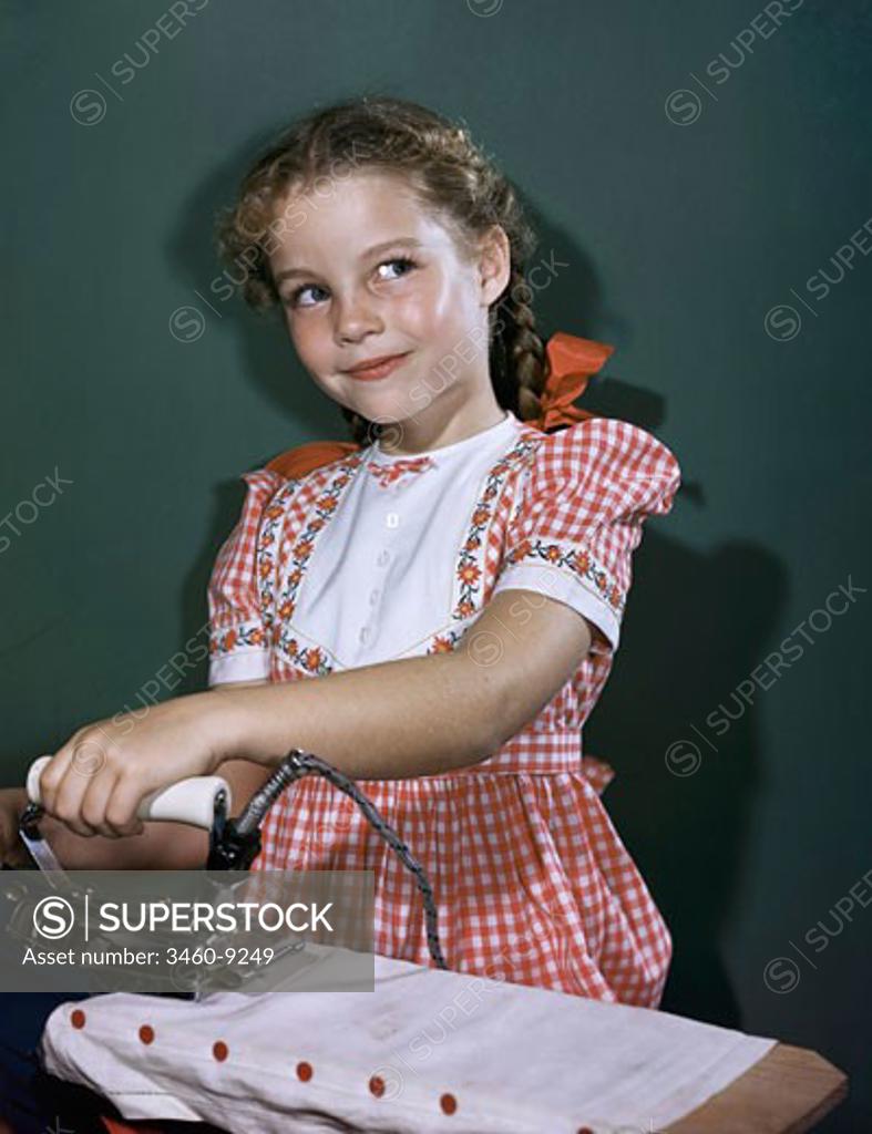 Stock Photo: 3460-9249 Close-up of a girl ironing clothes