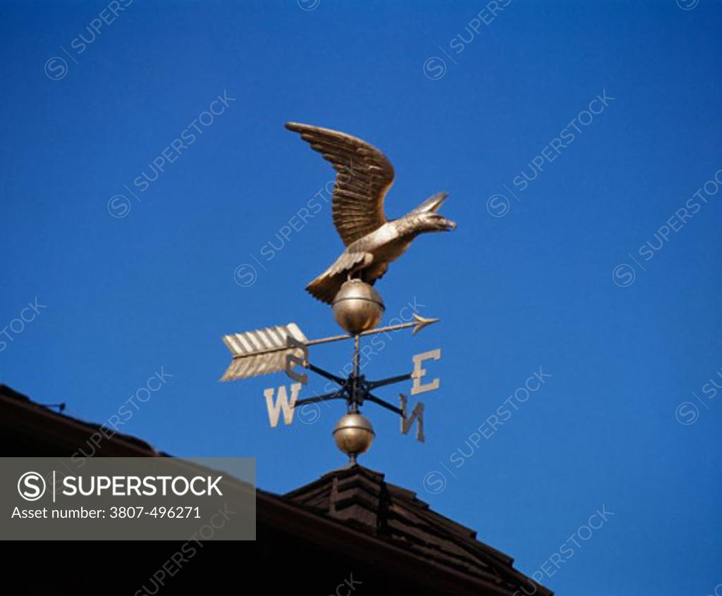Stock Photo: 3807-496271 Low angle view of a weather vane on the roof of a building