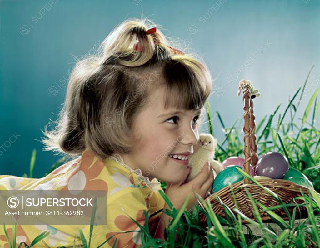Stock Photo: 3811-362982 Close-up of a girl holding a chick and smiling