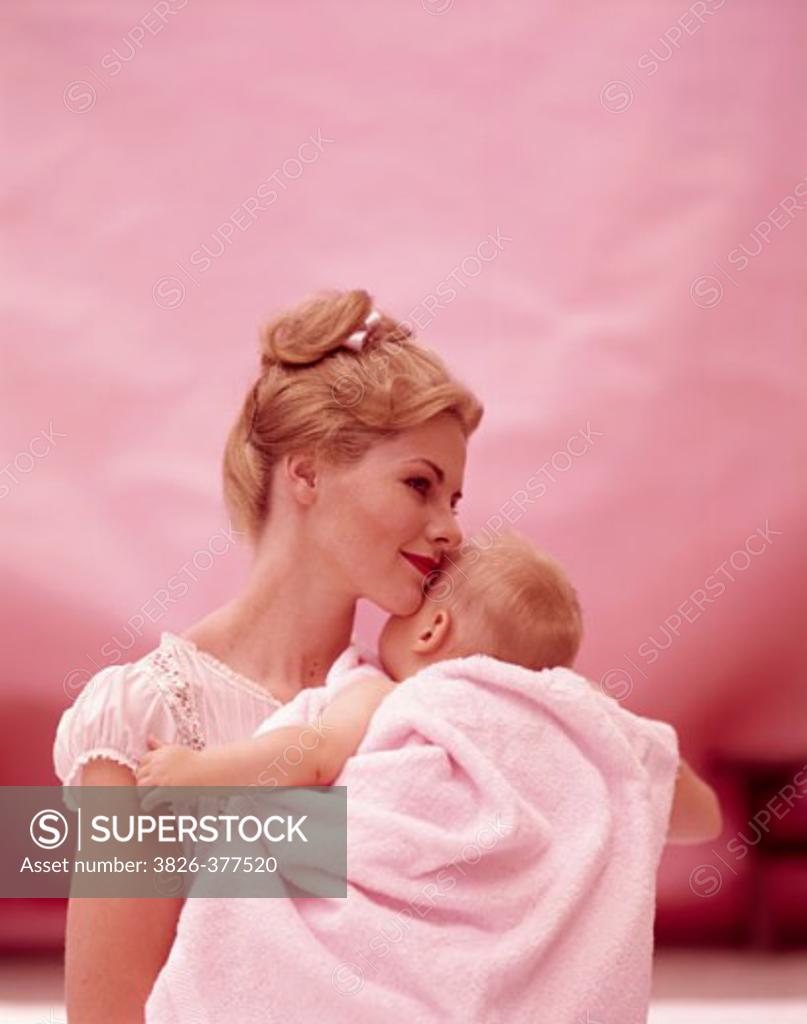 Stock Photo: 3826-377520 Close-up of a mid adult woman carrying her son