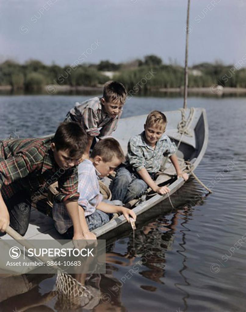 Stock Photo: 3844-10683 Four boys sitting in a boat and fishing