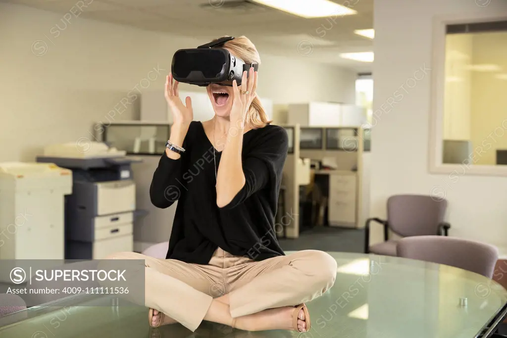 Woman looks surprised while wearing VR headset.