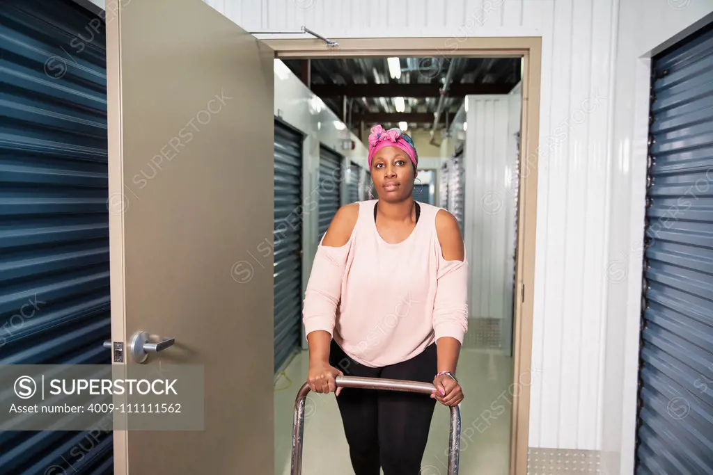 Close up of a woman walking the halls of a store facility.