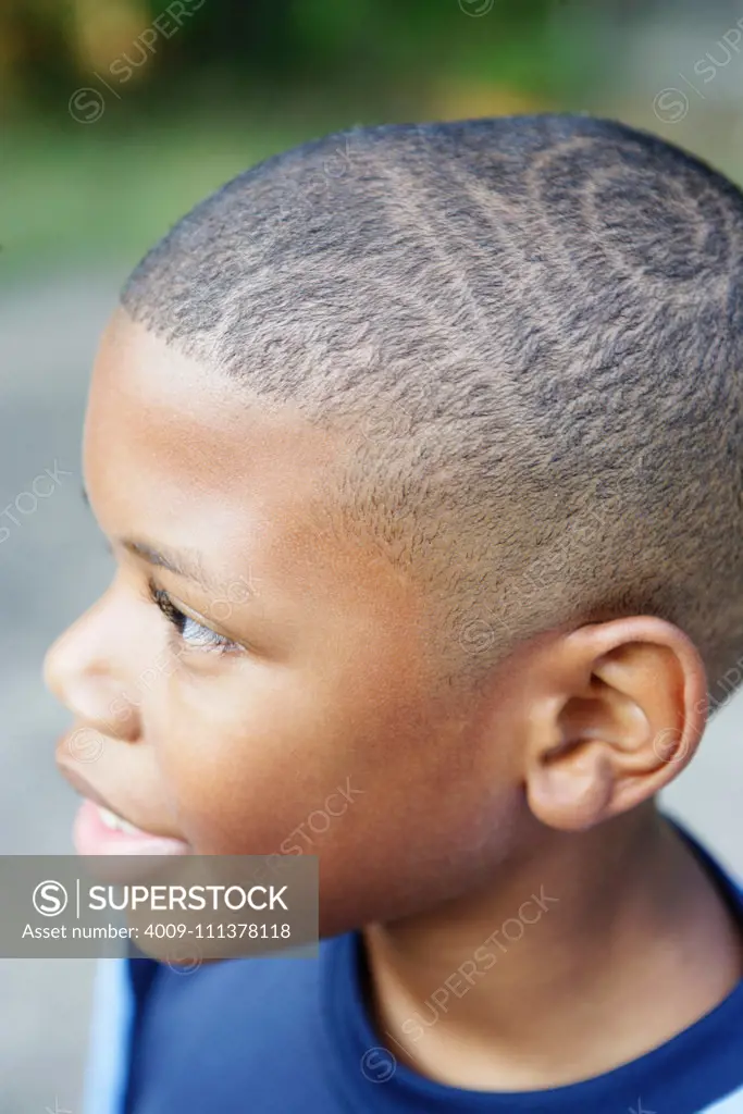 Close up of young boy's hair cut - SuperStock