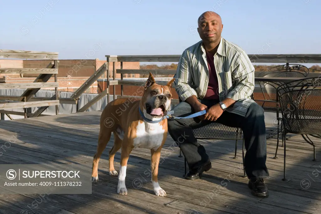 African man and dog on deck  - dogs