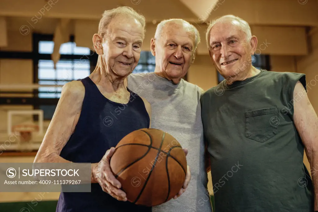 Elderly men playing basketball