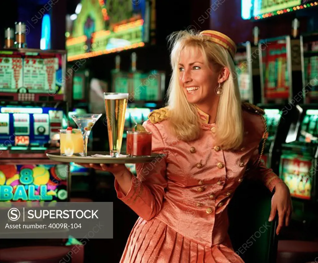 Casino waitress holding a tray of drinks and smiling