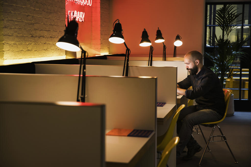 man working late in co-working space