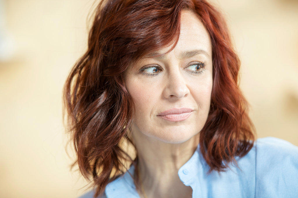 Close up portrait of red headed woman looking off camera.