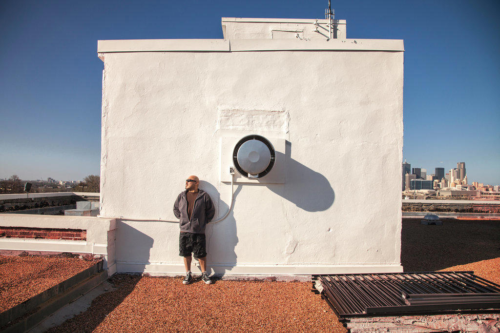 Man leaning on rooftop wall