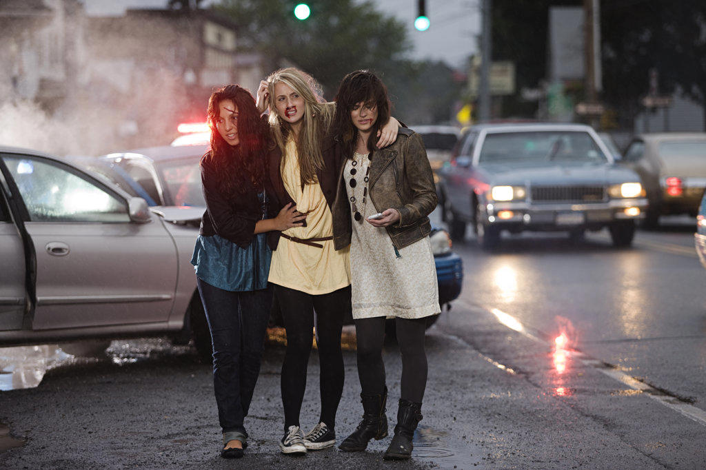 Three young women  walking away from automobile accident